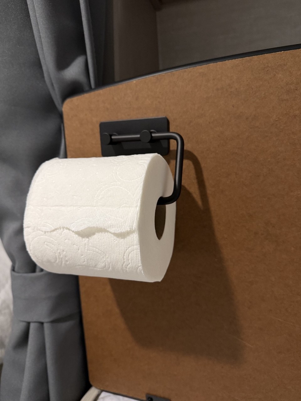 Installing rotating toilet paper holder with adhesive backing