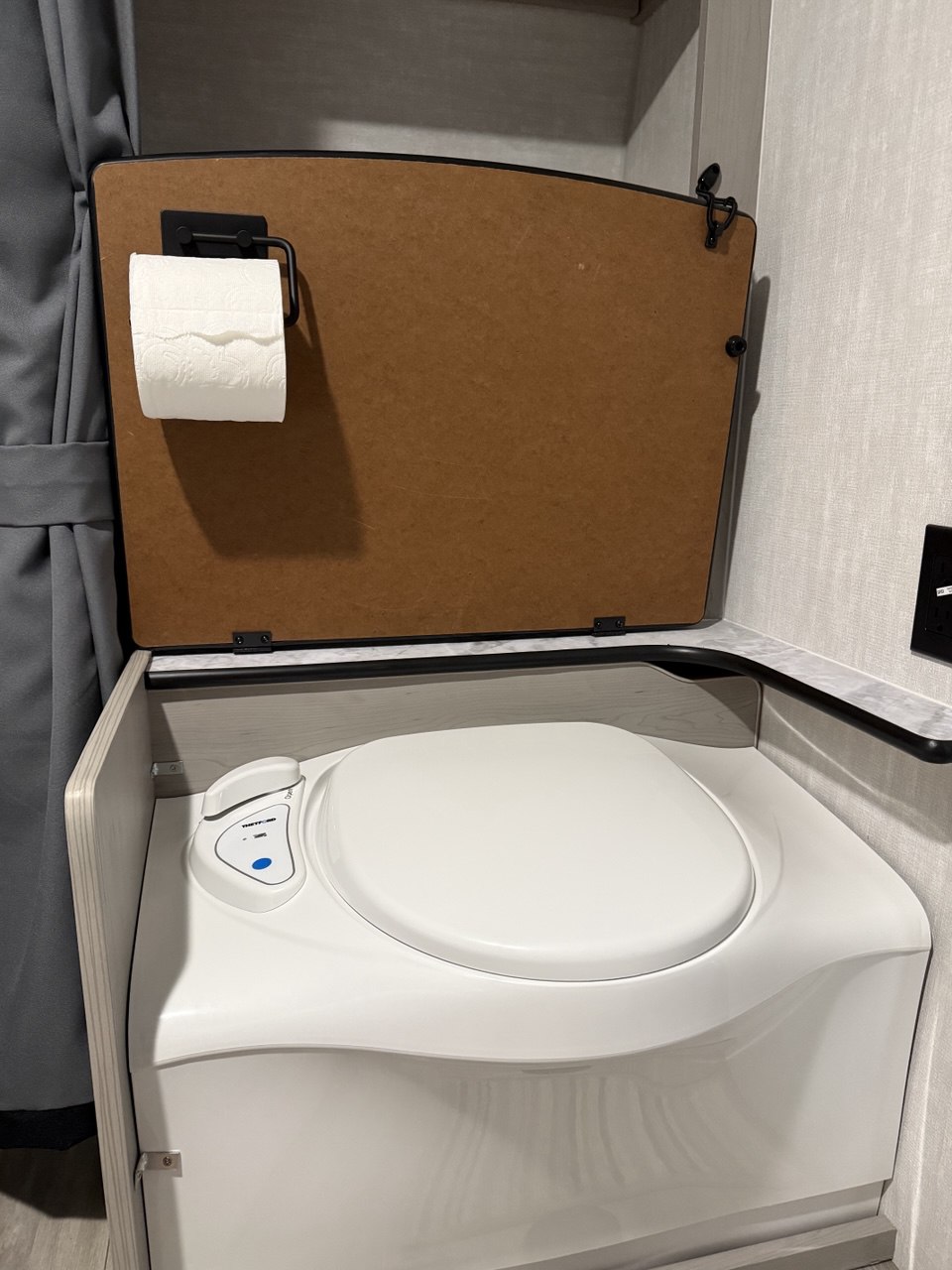 Toilet paper holder rotated down for easy access